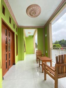 a hallway with benches and green walls at Ijen kingdom guest house in Tamansuruh +14 photos