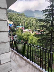a balcony with a view of a mountain at Swaran bnb near Mcleodganj in Dharamshala