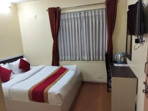 Letto o letti in una camera di Hotel Odyssey Nepal