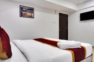 Postel nebo postele na pokoji v ubytování Hotel Orchard Park