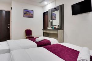 Postel nebo postele na pokoji v ubytování Hotel Orchard Park