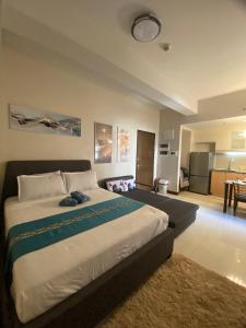 a bedroom with a large bed and a kitchen at A&G Condotel at 101 Newport Near NAIA T3 in Manila +38 photos