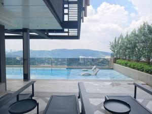 a view of a swimming pool from a building at Mossaz Suites Empire City By Starwood in Petaling Jaya