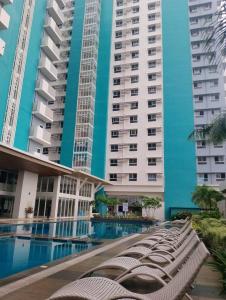a group of tall buildings with a swimming pool at Xavi's Condo Rental in Bacolod