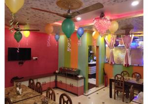 a room with a colorful wall with balloons and tables at Hotel Royal Paradise ! New Digha in Digha