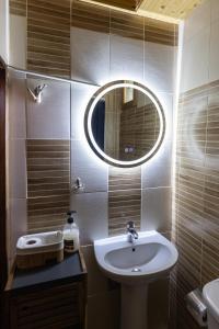 a bathroom with a sink and a mirror at Chalet Parea in Metamorfosi