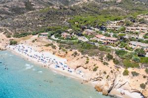 an aerial view of a beach with a group of people at Casa Turchese, Sea View Beachfront in Santa Margherita di Pula