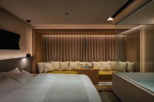 a hotel room with a large bed and a tub at HotelCO Kuramae ホテル コ 蔵前 in Tokyo