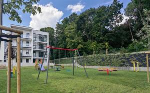 a playground in a yard with a building at Apartament Sosnowa in Puławy