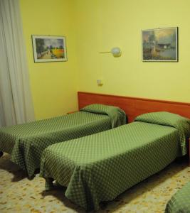 Postel nebo postele na pokoji v ubytování Albergo Casa Lupi