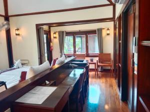 a living room with two couches and a table at Koh Mook Sivalai Beach Resort in Ko Mook