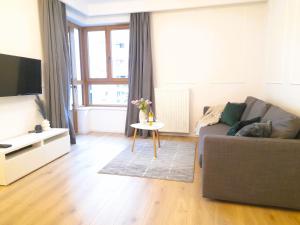 a living room with a couch and a table at Vista Residence Wola in Warsaw