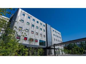 a large white building with windows on the side of it at dogo hakuro - Vacation STAY 80196v in Matsuyama