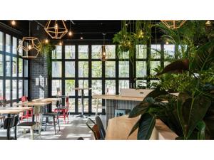 a restaurant with tables and chairs and large windows at dogo hakuro - Vacation STAY 80207v in Matsuyama