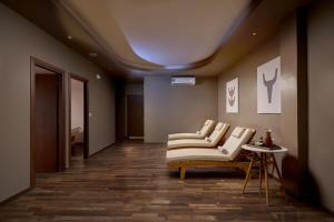 a living room with a couch and a table at Blue Sea Beach Resort in Faliraki