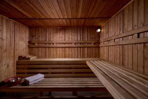a large wooden sauna with a bench in it at Blue Sea Beach Resort in Faliraki