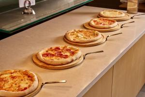 a group of pizzas sitting on top of a counter at Blue Sea Beach Resort in Faliraki