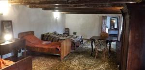 a bedroom with a bed and a desk and a table at Садиба Сцибор-Мархоцького in Otrokov