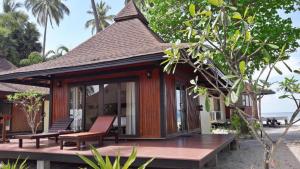 a resort with a deck and chairs on the beach at Koh Mook Sivalai Beach Resort in Ko Mook