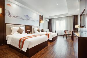 Ένα ή περισσότερα κρεβάτια σε δωμάτιο στο Rose Garden International Hotel