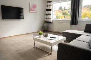 a living room with a couch and a coffee table at Villa Nordhang - Apartment 5 in Winterberg