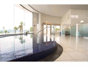 a large swimming pool in a building with a large window at Hotel Alegria Gardens Amakusa - Vacation STAY 40452v in Amakusa