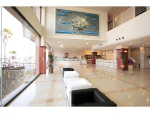 a lobby with white couches in a building at Hotel Alegria Gardens Amakusa - Vacation STAY 40452v in Amakusa