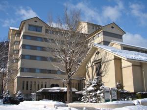 a large building with a tree in the snow at Aeria Tohno - Vacation STAY 62233v in Tōno +50 photos