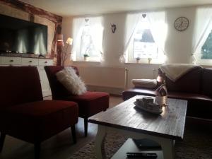 a living room with a couch and two chairs and a table at Ferienhaus Sankt Andreasberg in Sankt Andreasberg