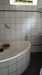 a white bath tub in a bathroom with a window at Ferienhaus Sankt Andreasberg in Sankt Andreasberg