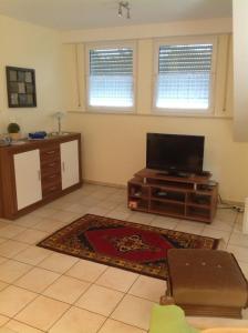 a living room with a flat screen tv on a table at Stapper's Landgasthaus Ferienwohnung in Ibbenbüren +4 photos