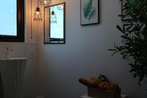 a bathroom with a mirror and a basket of bread at The Grand Diamond C Hotel in Trung Ðồng +165 photos
