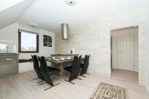 a dining room with a table and black chairs at Ferienwohnung Nilsson in Halstenbek