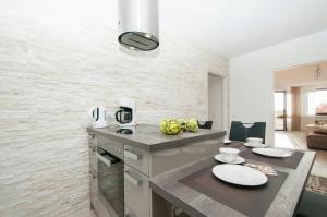 a kitchen with a table with plates on it at Ferienwohnung Nilsson in Halstenbek