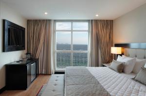 a bedroom with a large bed and a large window at Miramar By Windsor Copacabana in Rio de Janeiro
