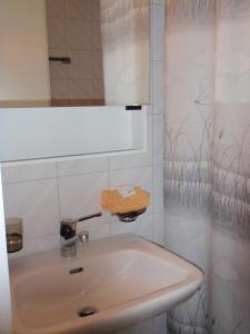 a bathroom with a sink and a mirror at Gasthof Löwen in Melchnau