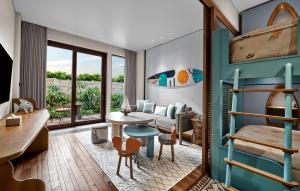 a living room with a couch and a table at Holiday Inn Resort Bali Canggu by IHG in Canggu