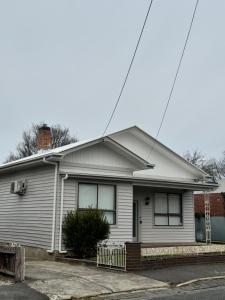 a white house with a roof at Pickaxe and Pillow in Ballarat