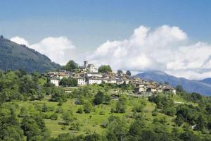 a town on top of a hill in a field at Curio Court Apartment in Curio