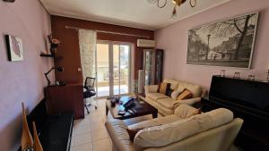 a living room with two couches and a television at Ήσυχο διαμέρισμα στην Ελευσίνα in Eleusis