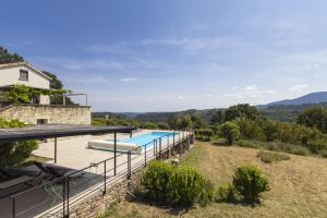 an external view of a villa with a swimming pool at Terre Rouge in Chambajour