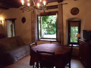 a living room with a table and a couch at Apt. La Grenouillère De Turckheim in Turckheim