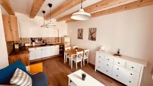a kitchen and living room with a table and chairs at Četnická Stanice Mšeno in Mšeno