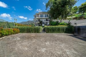 a brick driveway in front of a building at Adara Lake View Residence Bedugul - Bali in Bedugul