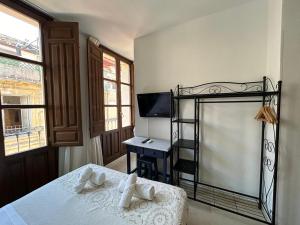 Postel nebo postele na pokoji v ubytování Hostal El Olivo