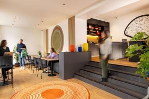 a lobby of a restaurant with people sitting at tables at Korner Saint Marcel in Paris