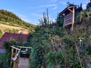 a house on the side of a hill with a walkway at Gemütliches Fachwerkhaus Hessen Thüringen in Herleshausen