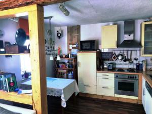 a kitchen with white appliances and a table in it at Gemütliches Fachwerkhaus Hessen Thüringen in Herleshausen