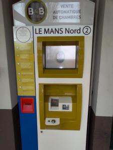 a gas pump in a building with a machine at B&B HOTEL Le Mans Nord 2 in Saint-Saturnin