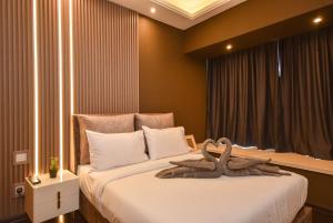 Postel nebo postele na pokoji v ubytování R&F Princess Cove by Nest Home at Johor Bahru